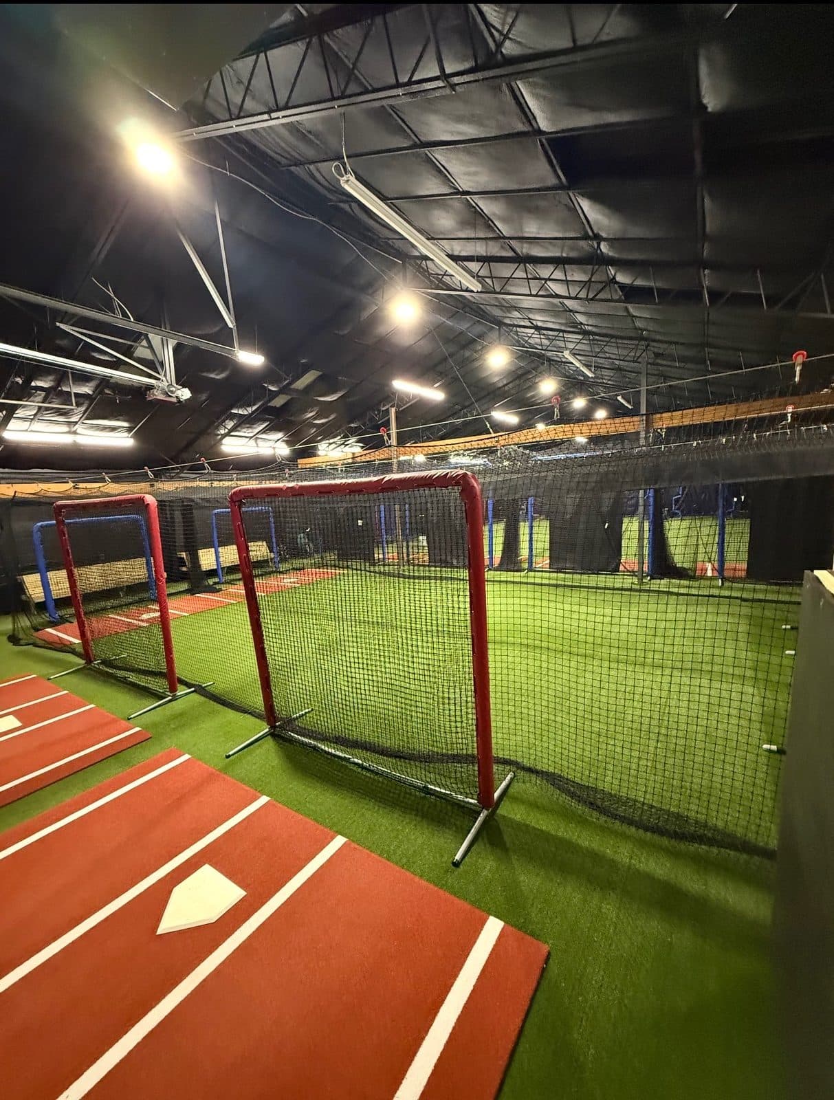 L-screen and home plate on the red lane turf