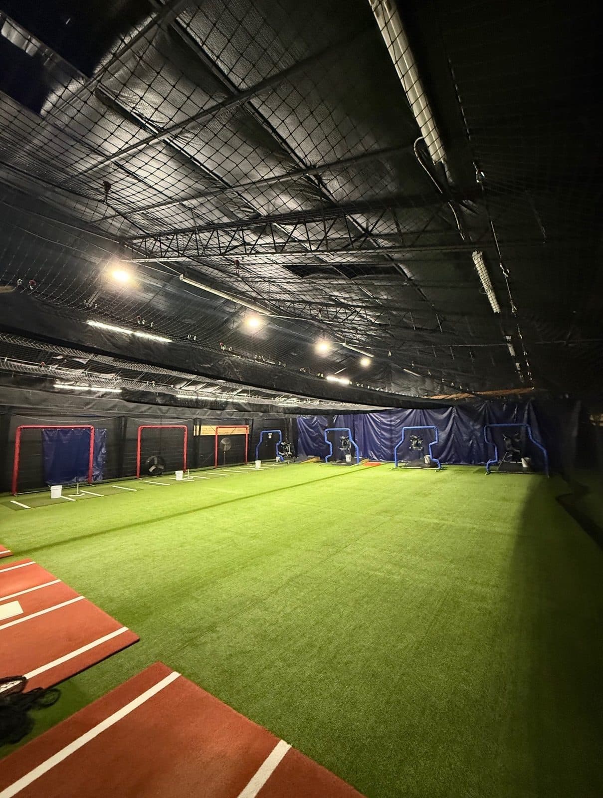 Long view down the turf toward the far batting tunnels