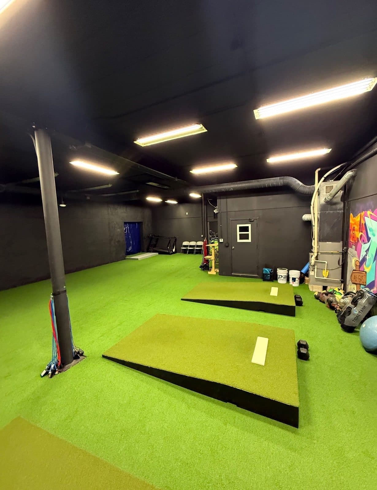 Portable pitching mounds on the turf training floor