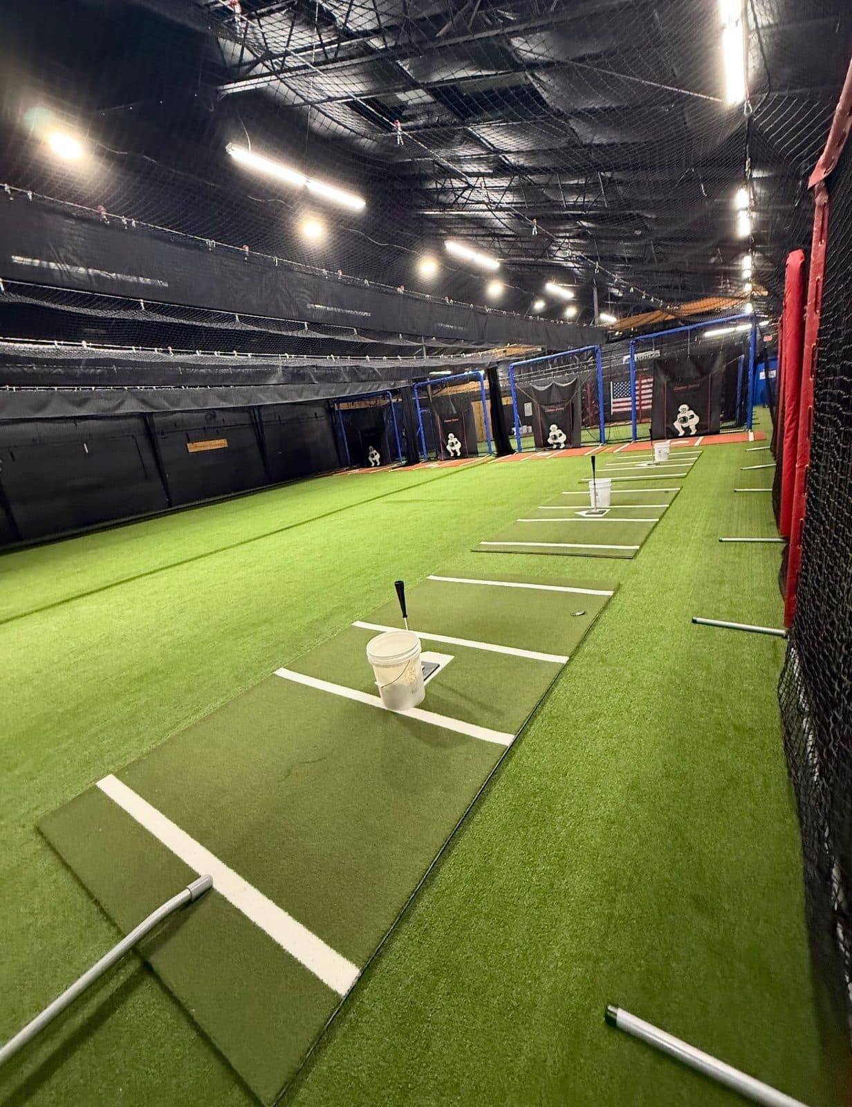 Hitting mat with a bucket of balls and a tee